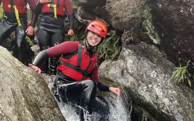 Person sitting on top of a small waterfall