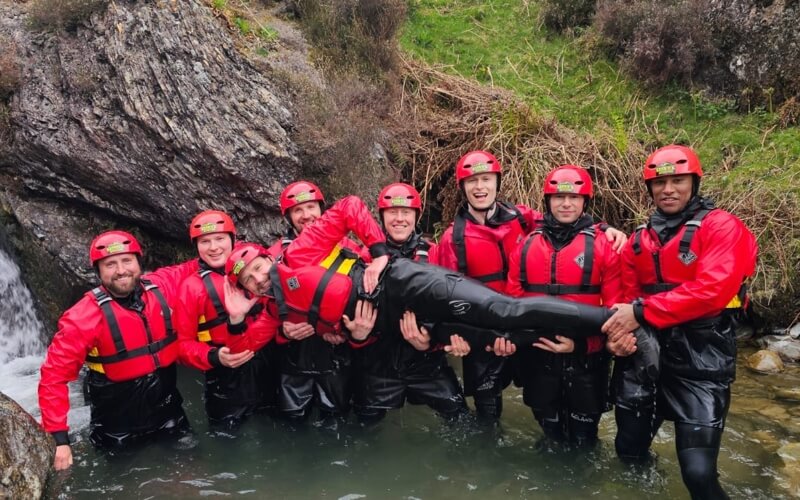 Stag do in the ghyll holding up the groom
