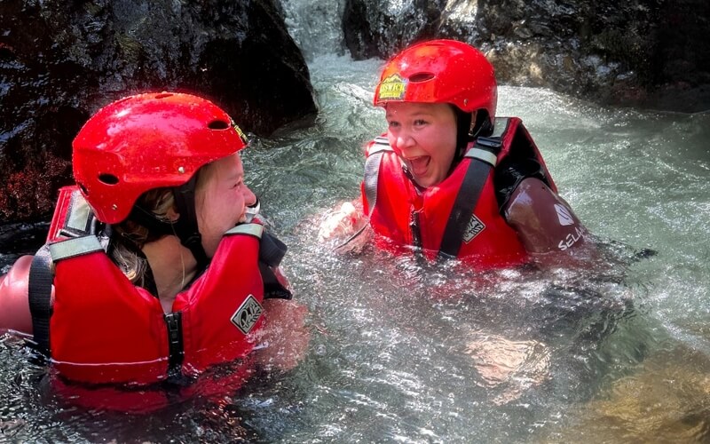 Two women looking happy and surprised in the ghyll