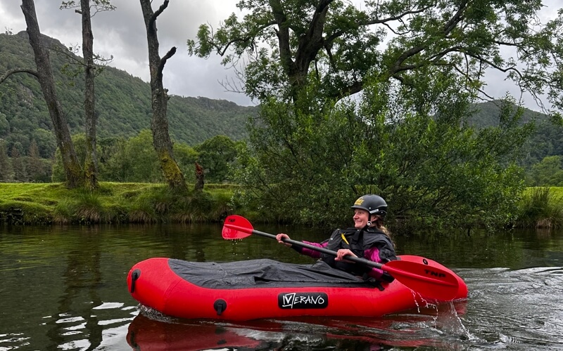 Woman packrafting in the Lake District