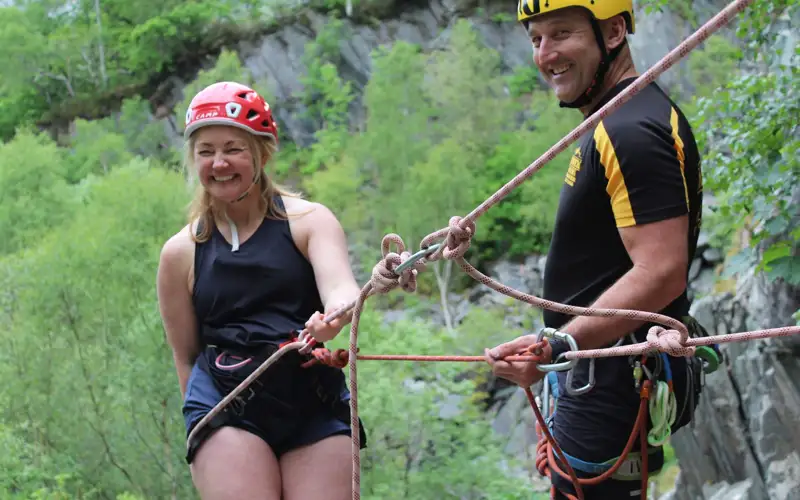 Woman laughing while abseiling