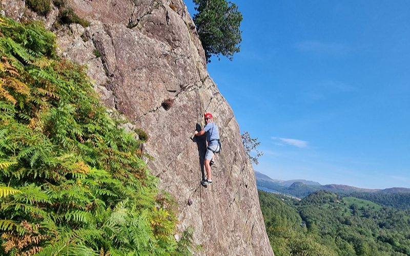 Man climbing up a cliff in the Lake District